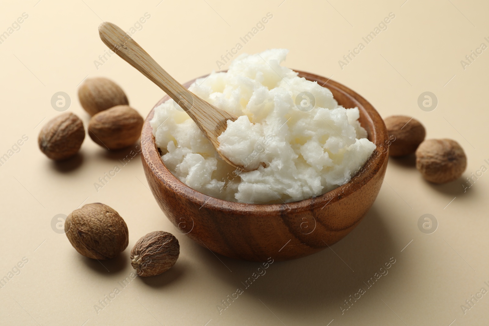 Natural shea butter and nuts on beige background, closeup Photo of Natural shea butter and nuts on beige background, closeup