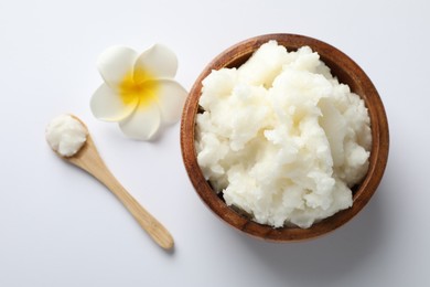 Photo of Natural shea butter and plumeria flower on white background, flat lay
