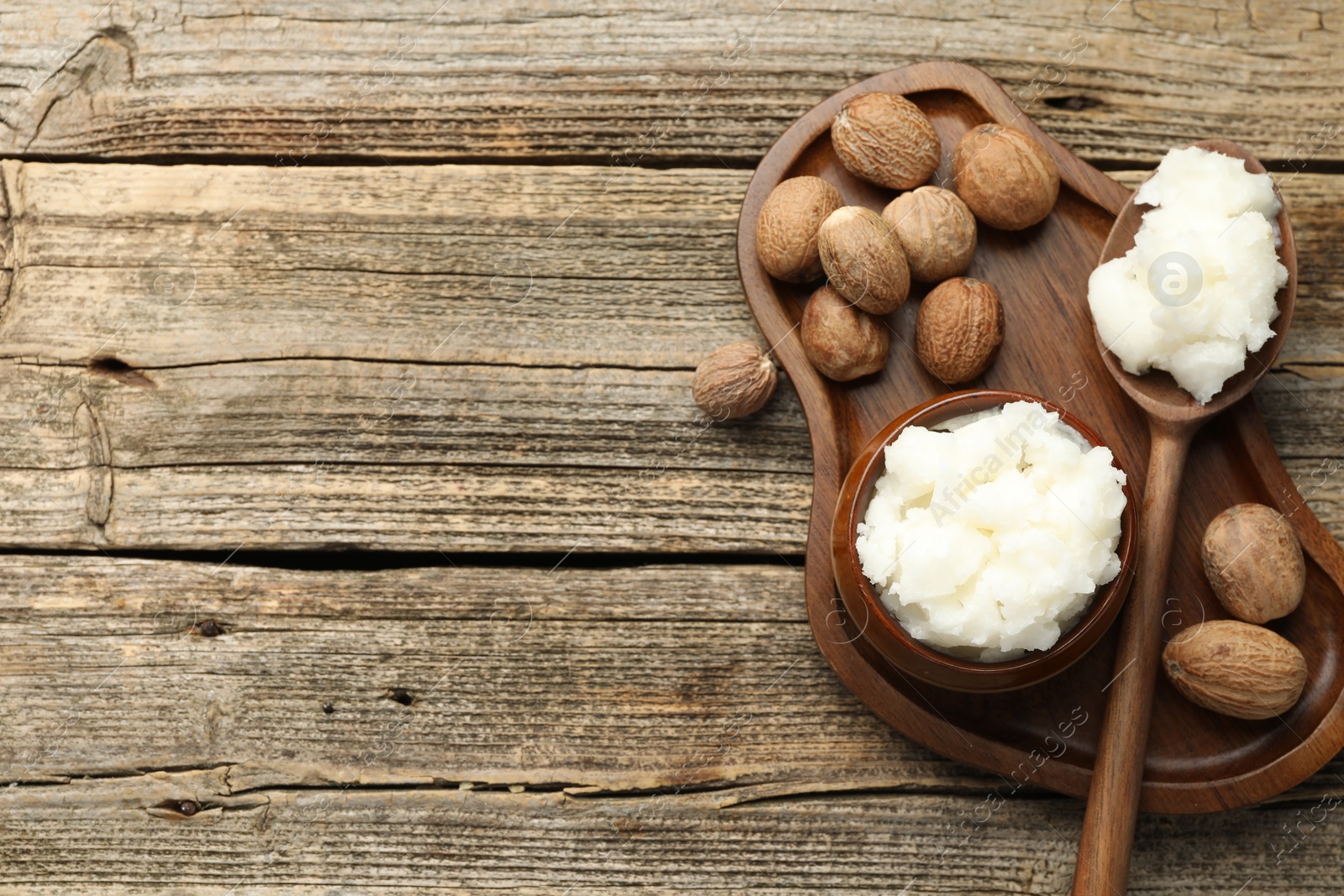 Natural shea butter and nuts on wooden table, top view. Space for text Photo of Natural shea butter and nuts on wooden table, top view. Space for text