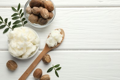 Photo of Natural shea butter on white wooden table, flat lay. Space for text
