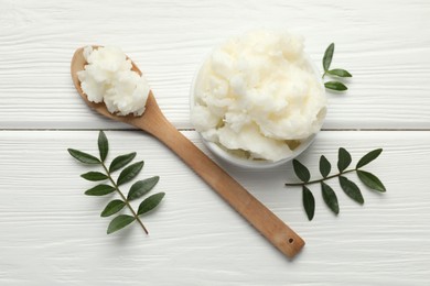 Photo of Natural shea butter and leaves on white wooden table, flat lay