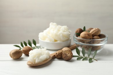Photo of Natural shea butter on white wooden table, closeup