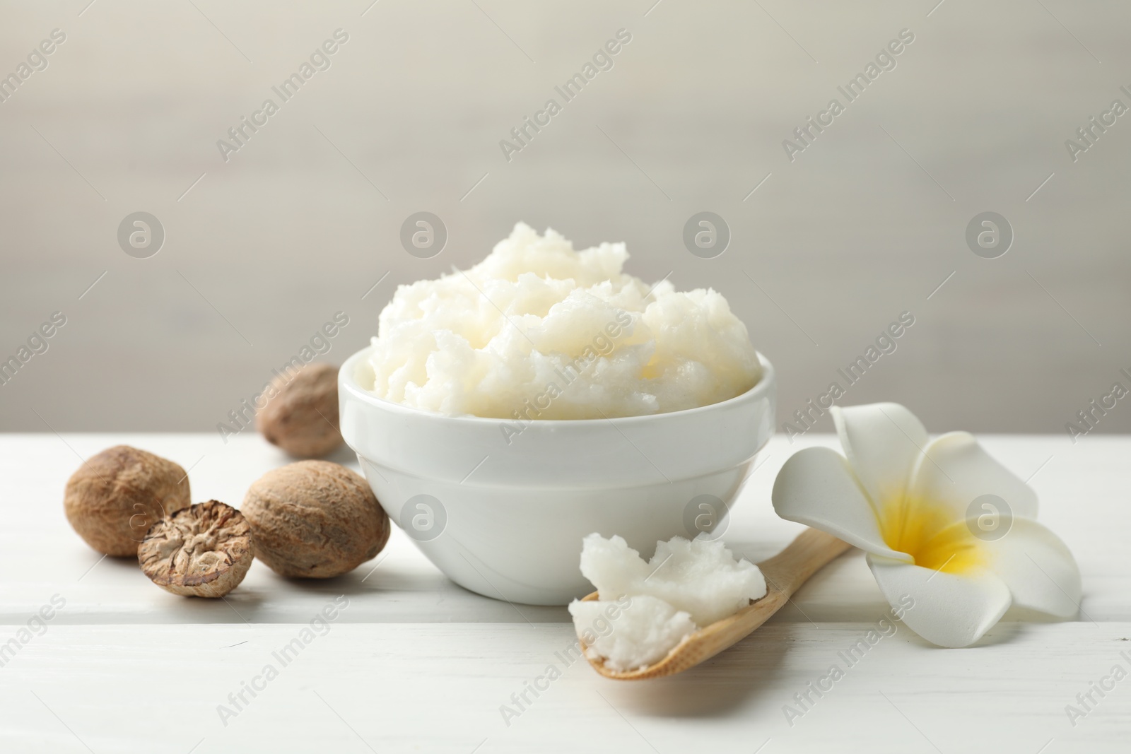 Natural shea butter on white wooden table, closeup Photo of Natural shea butter on white wooden table, closeup