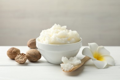 Photo of Natural shea butter on white wooden table, closeup