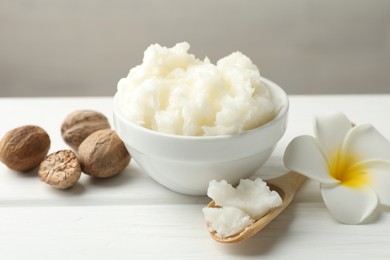 Photo of Natural shea butter on white wooden table, closeup