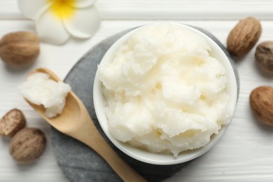 Photo of Natural shea butter on white wooden table, flat lay