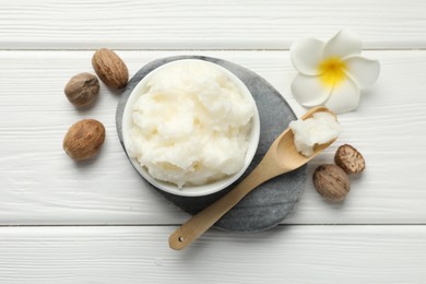 Photo of Natural shea butter on white wooden table, flat lay