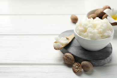 Photo of Natural shea butter on white wooden table, closeup. Space for text