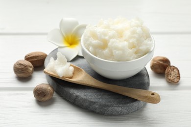 Photo of Natural shea butter on white wooden table, closeup