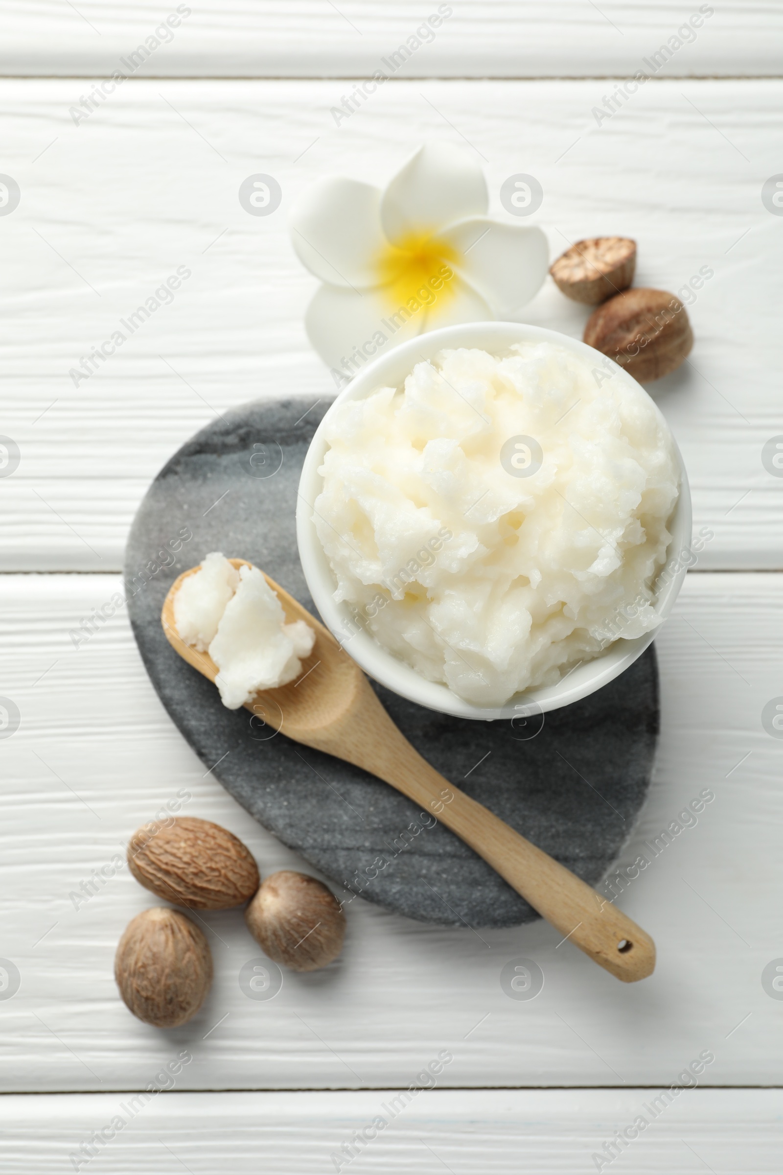 Natural shea butter on white wooden table, flat lay Photo of Natural shea butter on white wooden table, flat lay