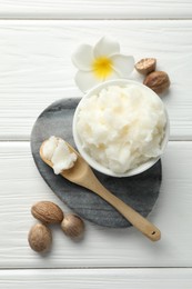 Photo of Natural shea butter on white wooden table, flat lay