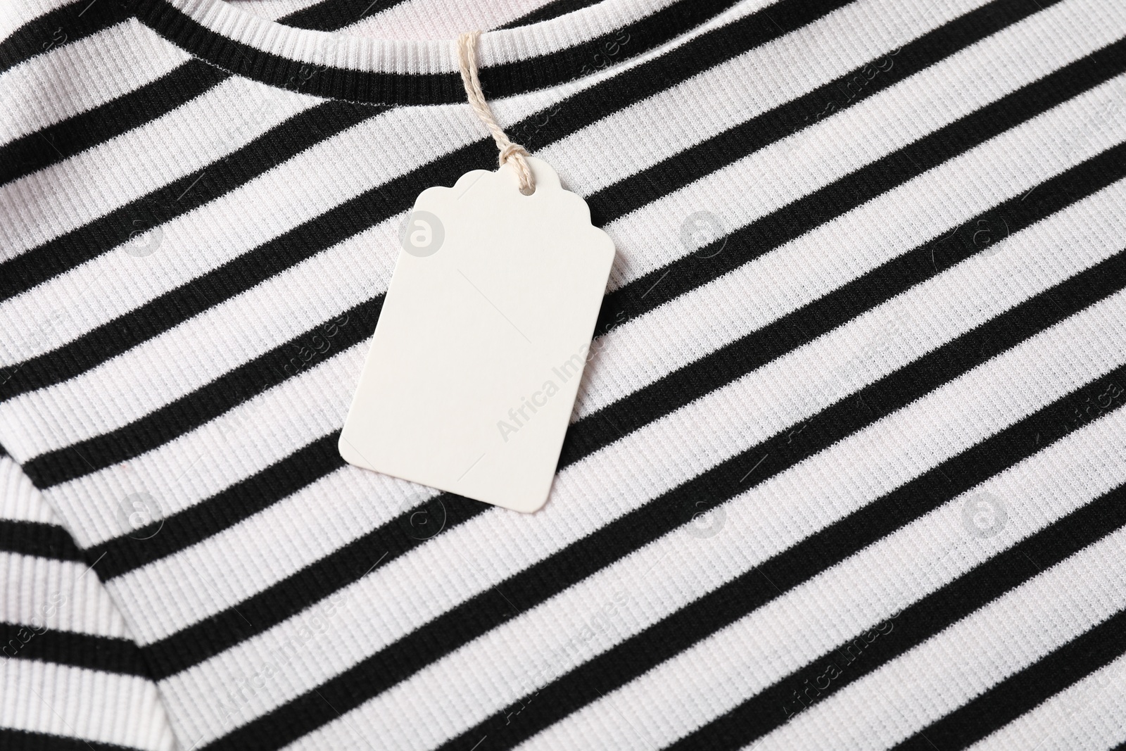 Cardboard tag on striped t-shirt, above view Photo of Cardboard tag on striped t-shirt, above view