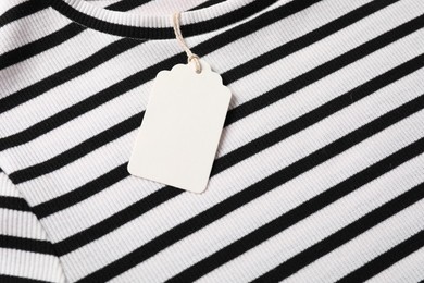 Photo of Cardboard tag on striped t-shirt, above view