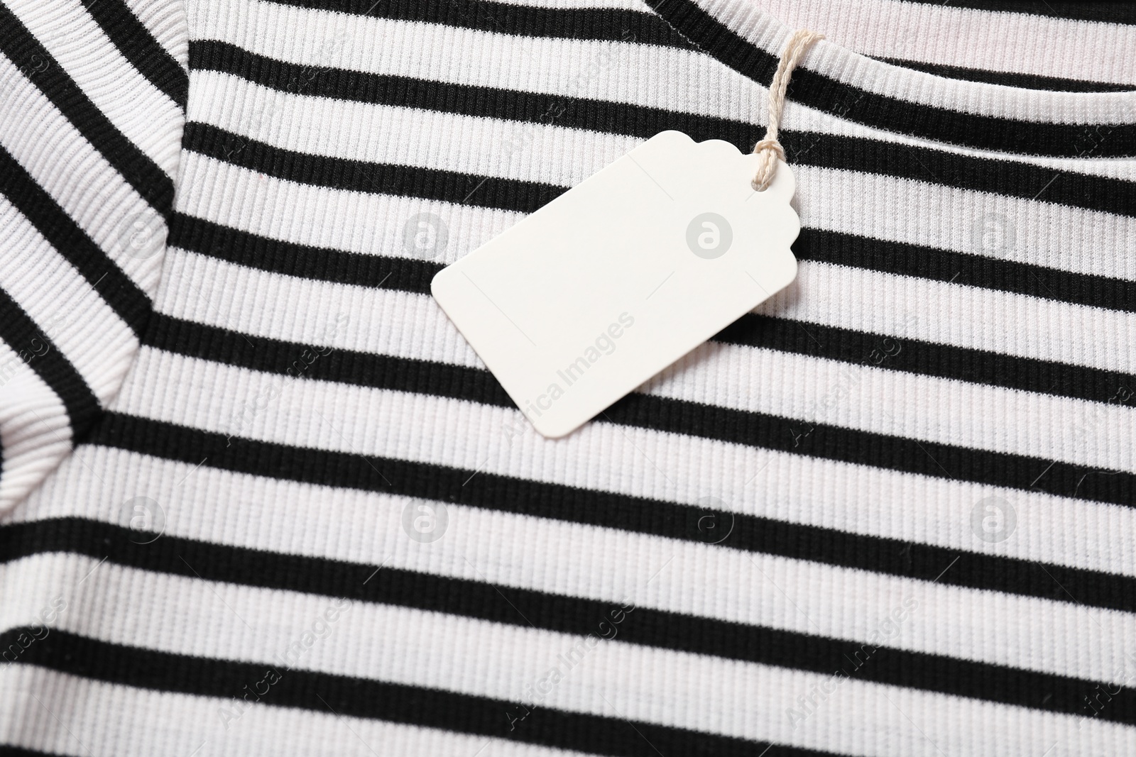 Cardboard tag on striped t-shirt, above view Photo of Cardboard tag on striped t-shirt, above view