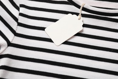 Photo of Cardboard tag on striped t-shirt, above view