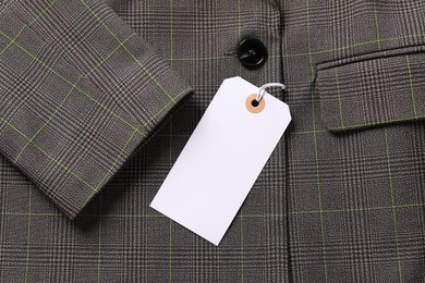 Photo of Cardboard tag on grey jacket, top view
