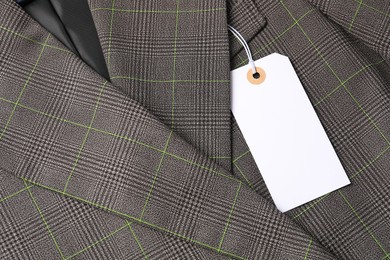 Photo of Cardboard tag on grey jacket, top view