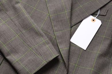 Photo of Cardboard tag on grey jacket, top view