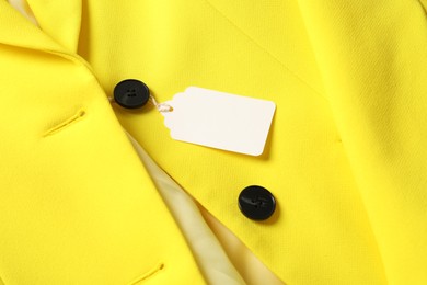 Photo of Cardboard tag on yellow jacket, above view
