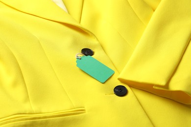 Photo of Cardboard tag on yellow jacket, closeup view