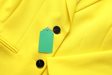 Photo of Cardboard tag on yellow jacket, top view