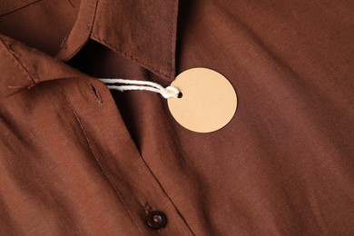 Photo of Cardboard tag on brown shirt, above view