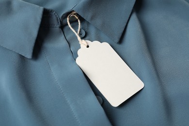 Photo of Cardboard tag on blue shirt, above view