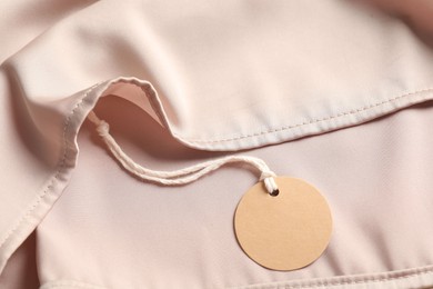 Photo of Cardboard tag on silk garment, top view