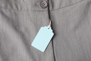 Photo of Cardboard tag on grey pants, top view