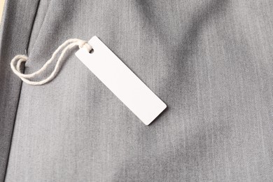 Photo of Cardboard tag on grey pants, above view