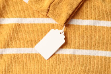 Photo of Cardboard tag on color garment, top view