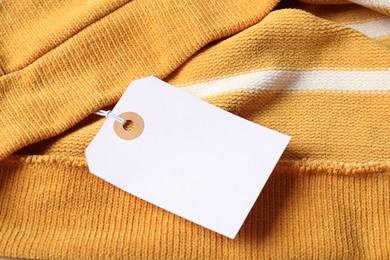 Photo of Cardboard tag on color garment, above view