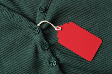 Photo of Cardboard tag on green cloth, top view