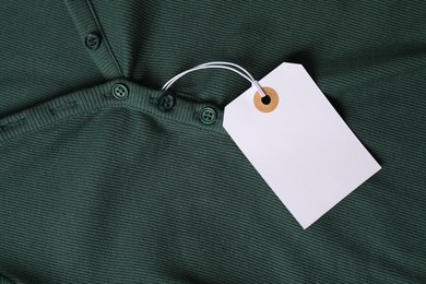 Photo of Cardboard tag on green cloth, top view