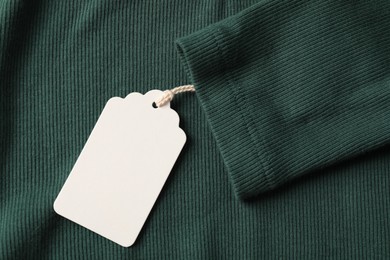Photo of Cardboard tag on green cloth, top view