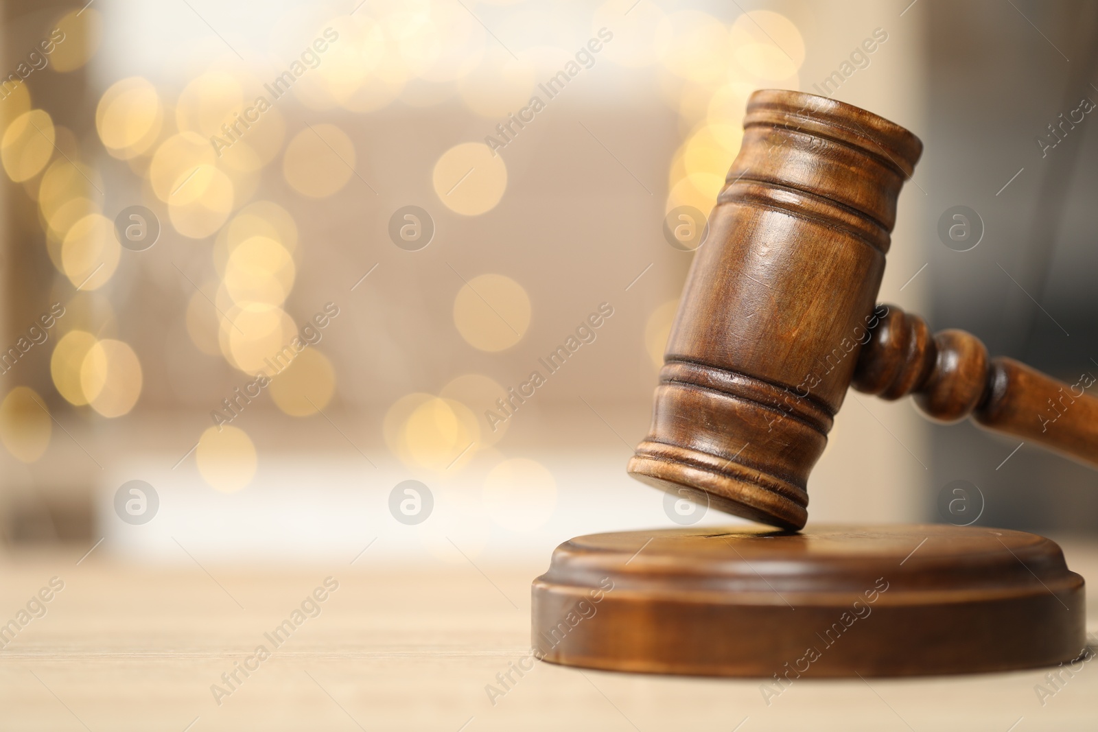 Judge's gavel on wooden table in office, closeup. Bokeh effect Photo of Judge's gavel on wooden table in office, closeup. Bokeh effect