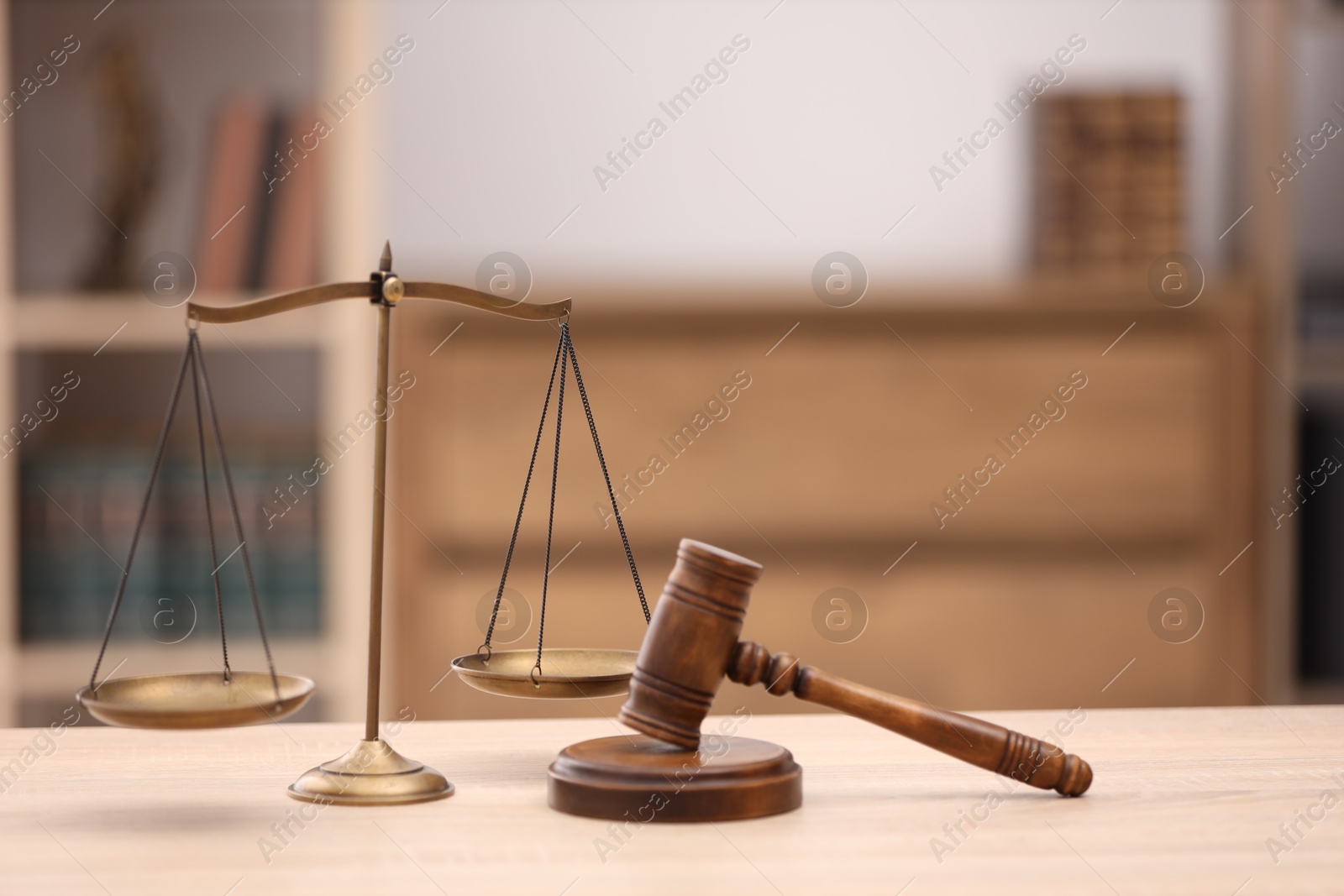Judge's gavel and scales on wooden table in office Photo of Judge's gavel and scales on wooden table in office