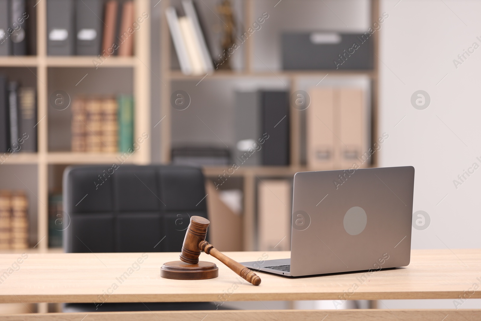 Judge's gavel and laptop on wooden table in office Photo of Judge's gavel and laptop on wooden table in office