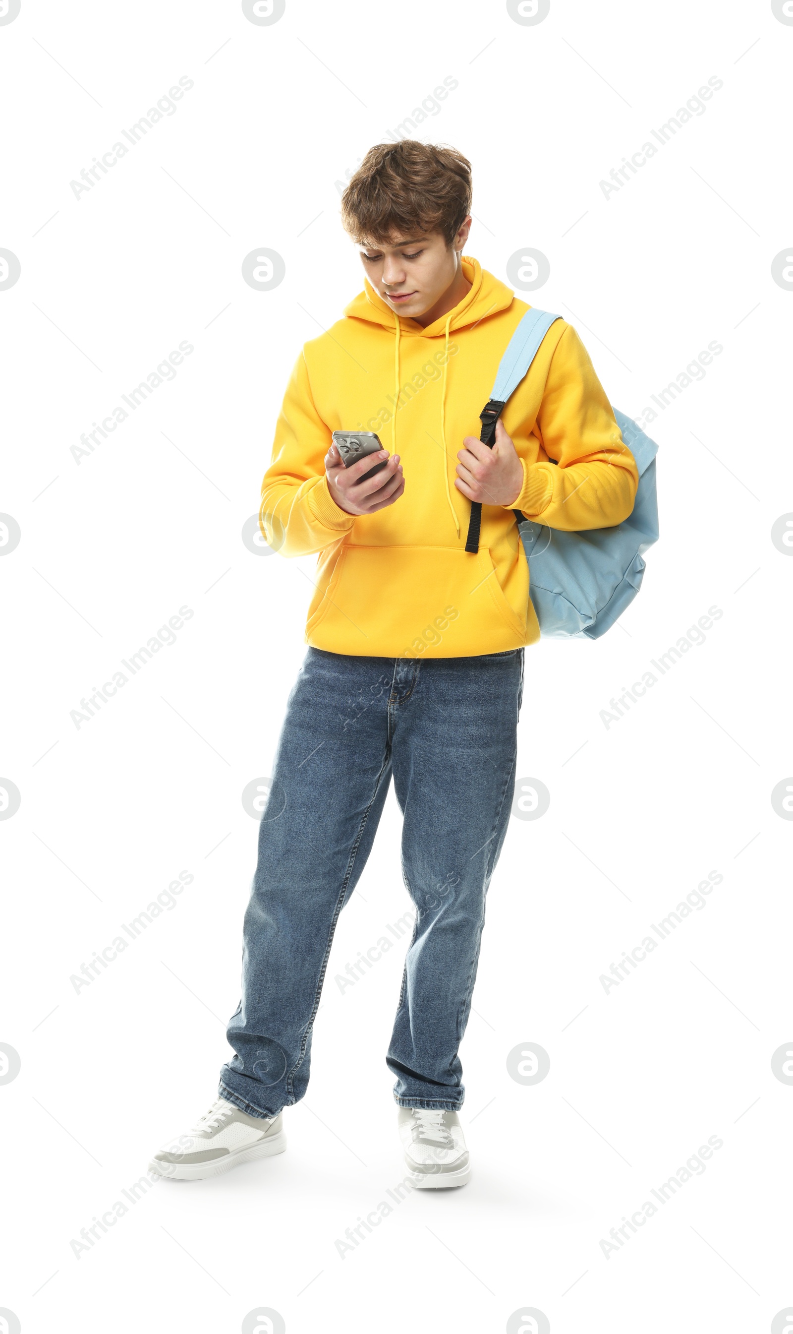 Teenage boy with smartphone and backpack on white background Photo of Teenage boy with smartphone and backpack on white background