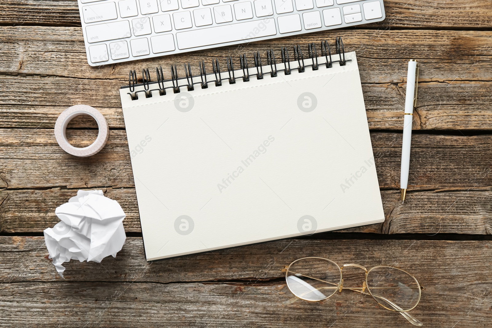 Photo of Flat lay composition with notebook on wooden table