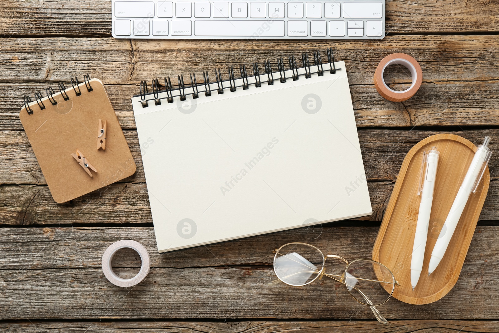 Photo of Flat lay composition with notebook on wooden table
