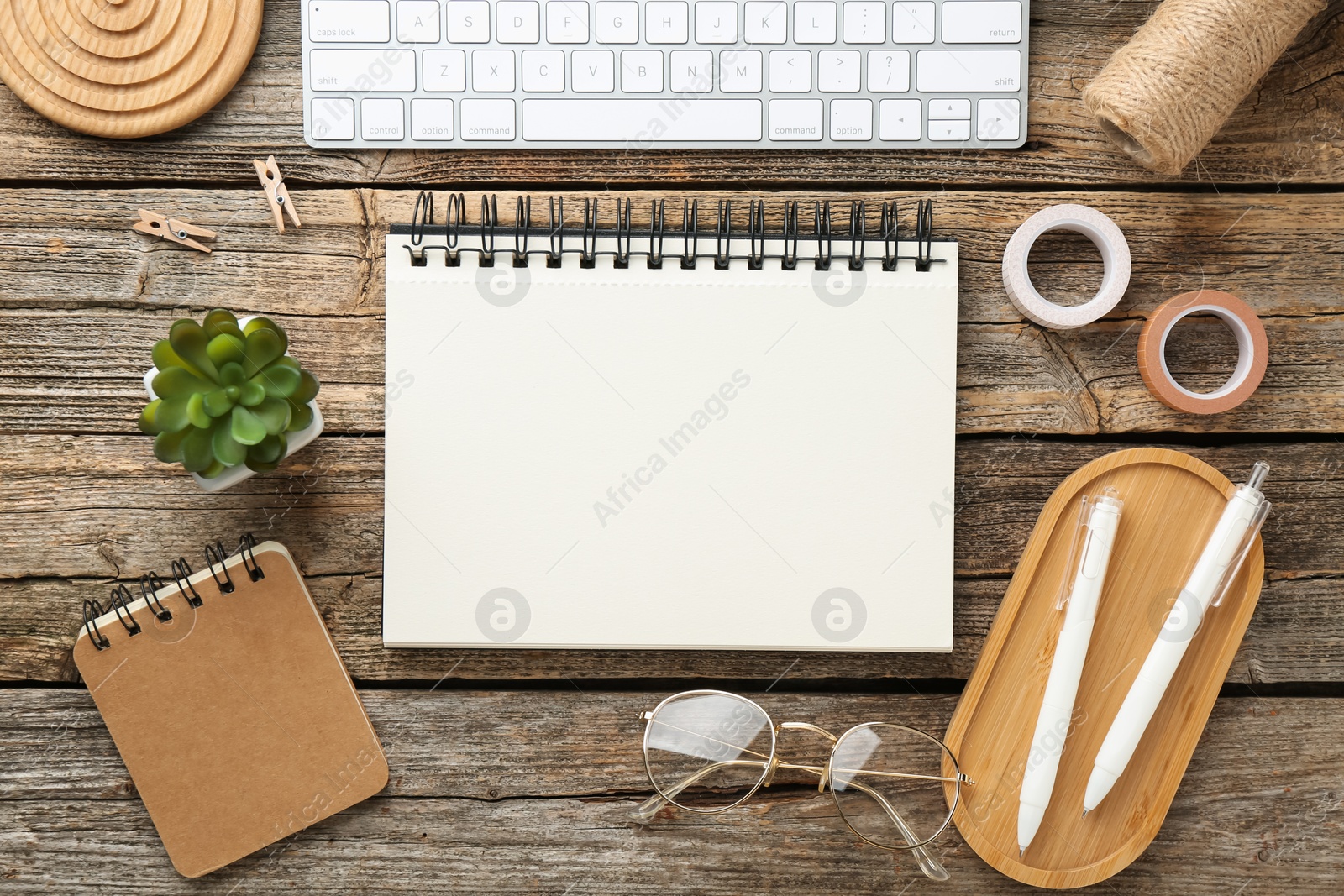 Photo of Flat lay composition with notebook on wooden table