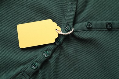 Photo of Cardboard tag on green cloth, top view