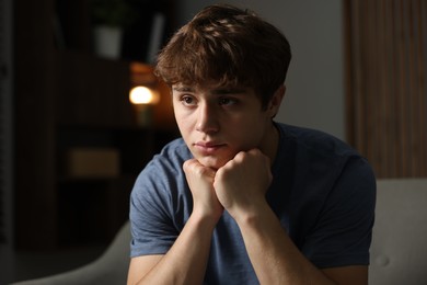 Photo of Teen problems. Upset teenage boy on sofa at home