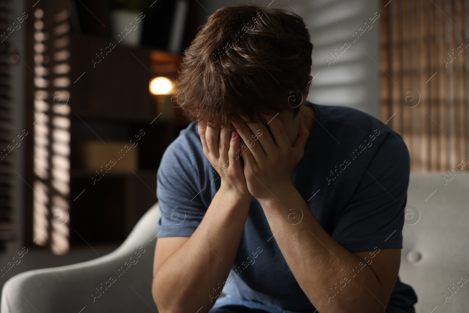 Teen problems. Depressed teenage boy on sofa at home Photo of Teen problems. Depressed teenage boy on sofa at home