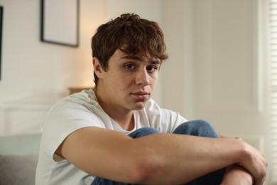 Photo of Teen problems. Upset teenage boy at home