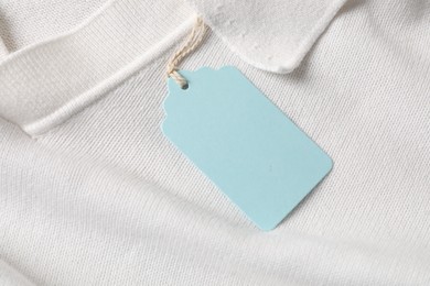 Photo of Cardboard tag on white garment, above view