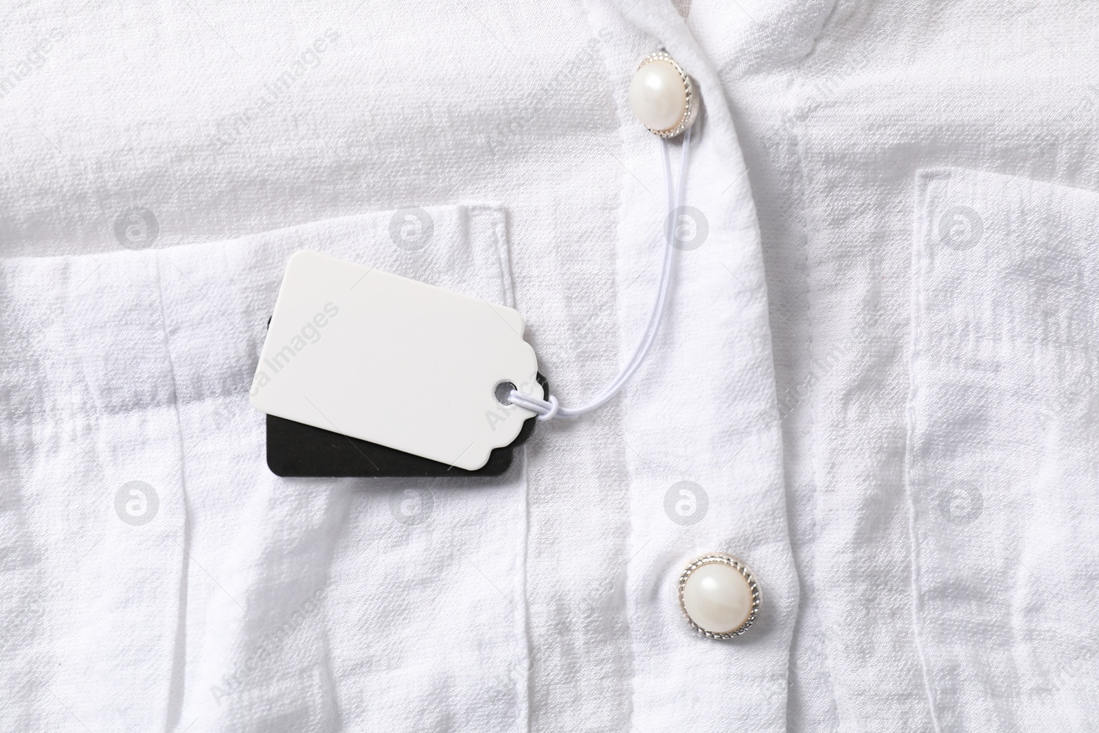 Cardboard tags on white shirt, top view Photo of Cardboard tags on white shirt, top view