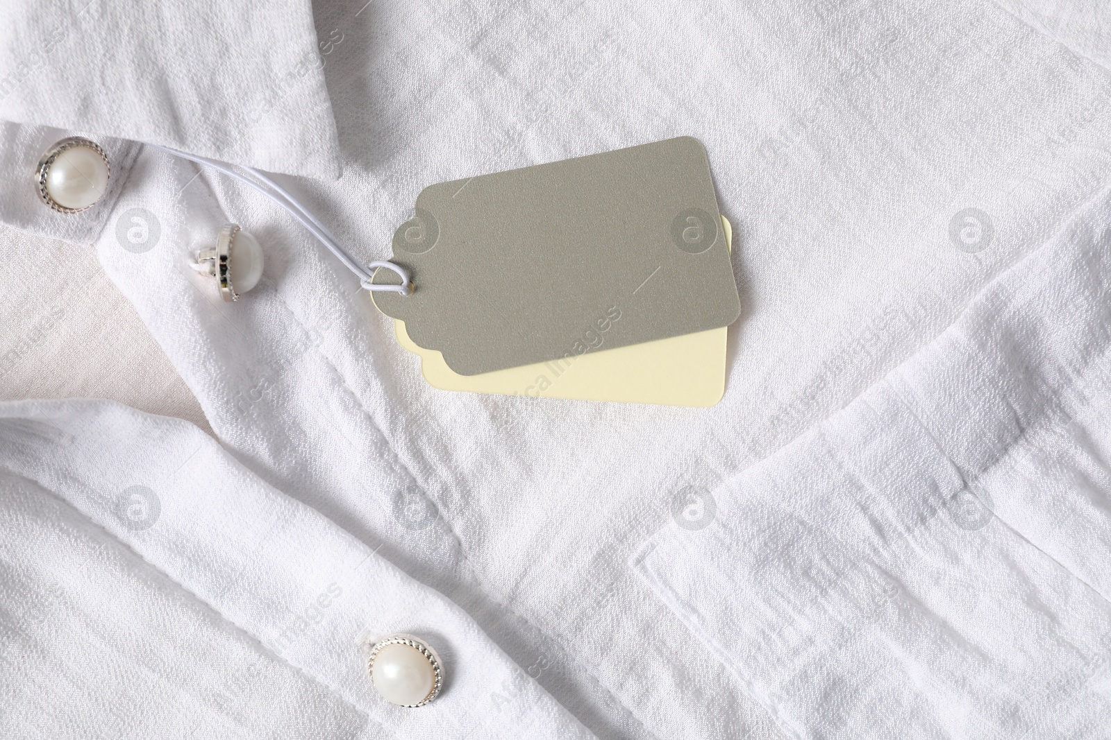 Cardboard tags on white shirt, top view Photo of Cardboard tags on white shirt, top view
