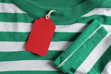 Photo of Cardboard tag on striped garment, top view